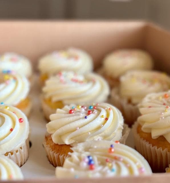 Boxed vanilla swirl cupcakes with pearl sprinkles
