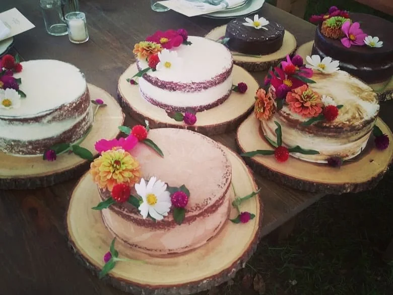 Humble Crumb floral cakes arranged together on a wedding dessert table